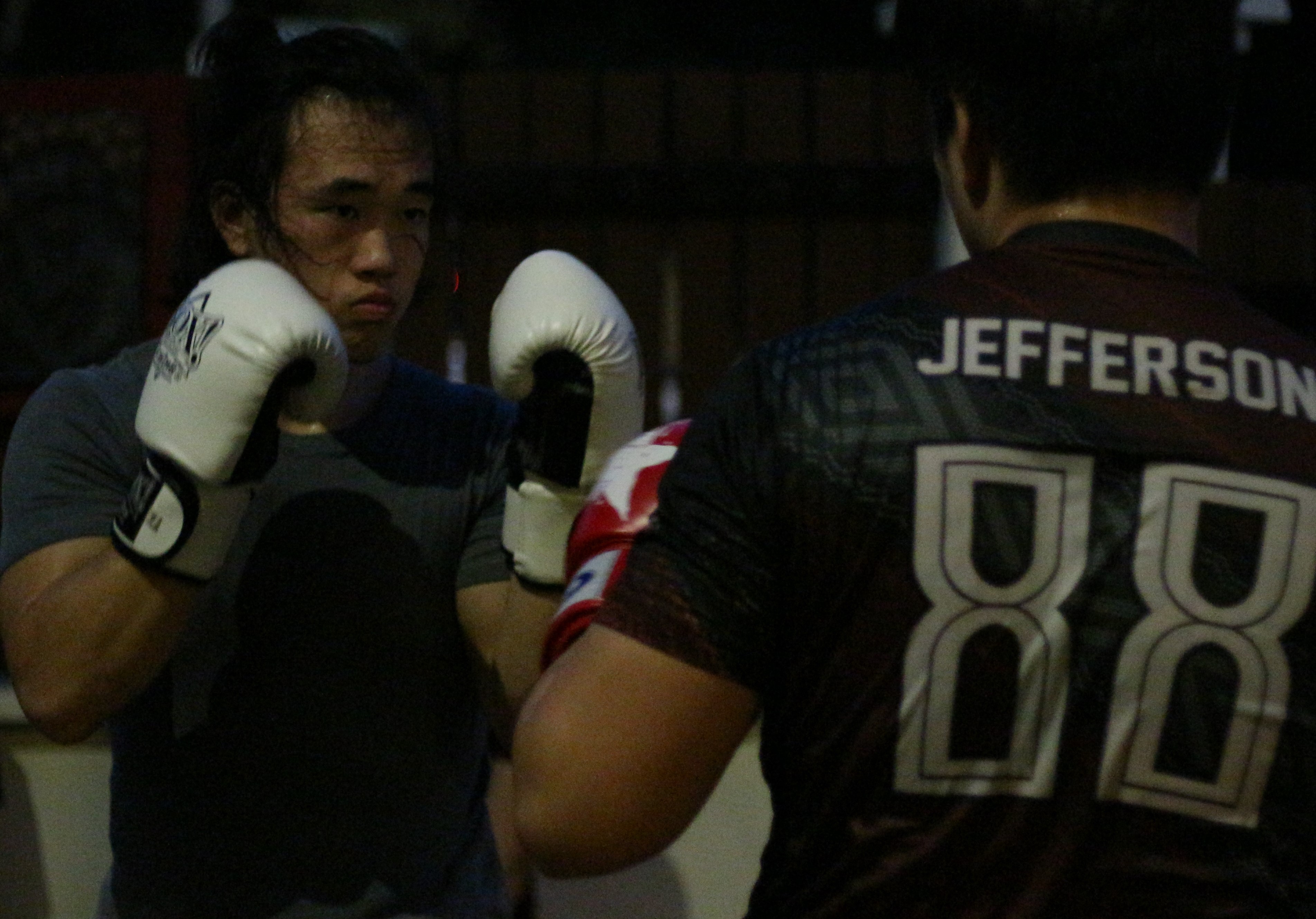 lady practicing muay thai with partner
